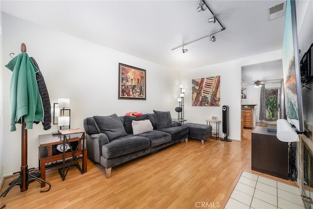 living room with ceiling fan, track lighting, and light wood-type flooring