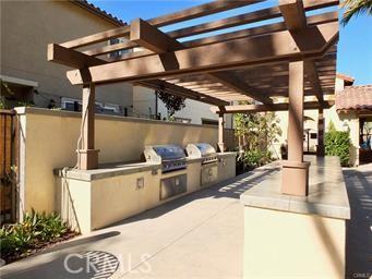 view of patio with area for grilling, grilling area, and a pergola