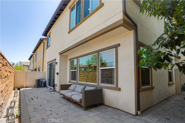 view of property exterior featuring central AC unit and a patio