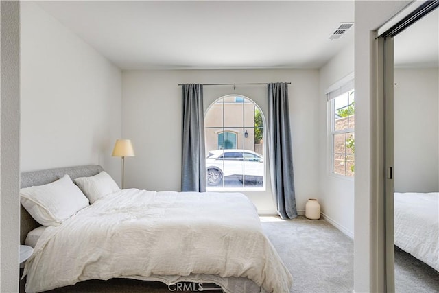 bedroom featuring light colored carpet