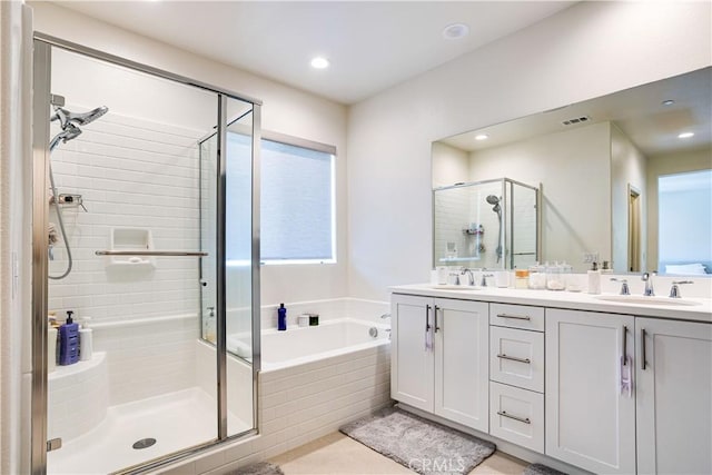 bathroom with vanity, shower with separate bathtub, and tile patterned flooring