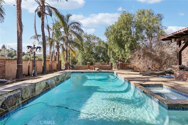 view of pool with an in ground hot tub and pool water feature