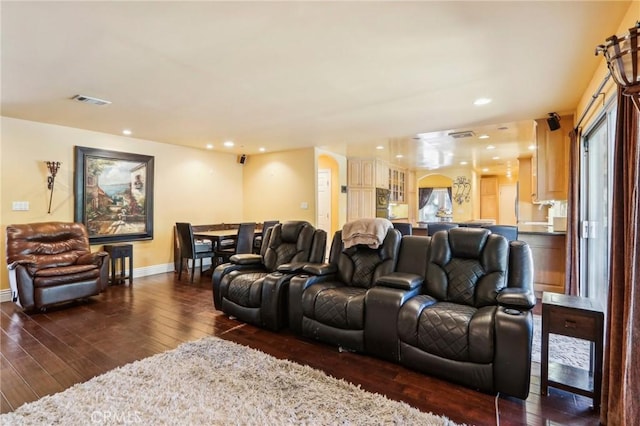 home theater room featuring dark wood-type flooring