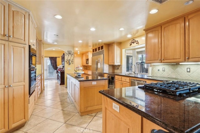 kitchen with stainless steel appliances, a center island, wine cooler, decorative backsplash, and dark stone counters