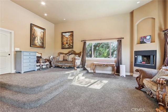 living area featuring a fireplace and carpet