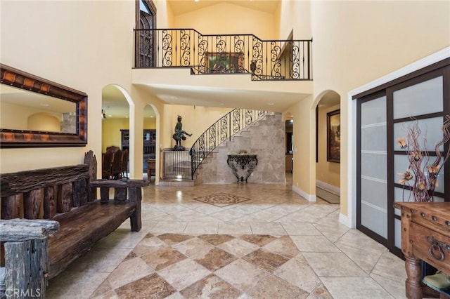 entrance foyer featuring high vaulted ceiling