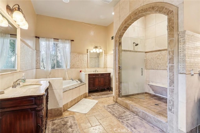 bathroom featuring vanity and shower with separate bathtub