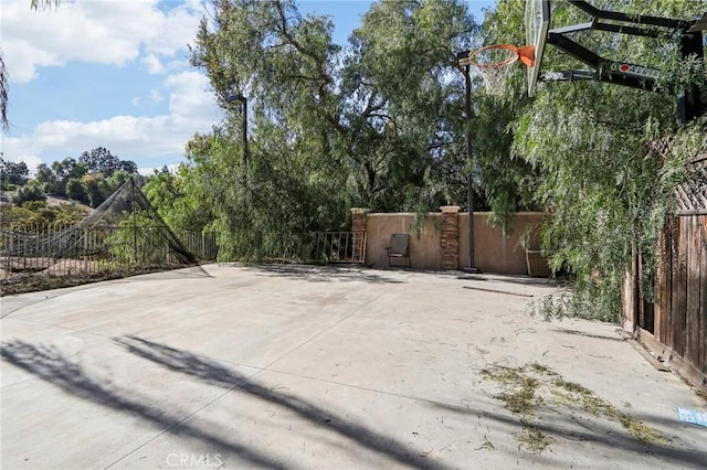 view of patio / terrace with basketball hoop