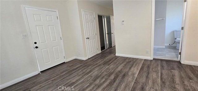 empty room featuring dark wood-type flooring