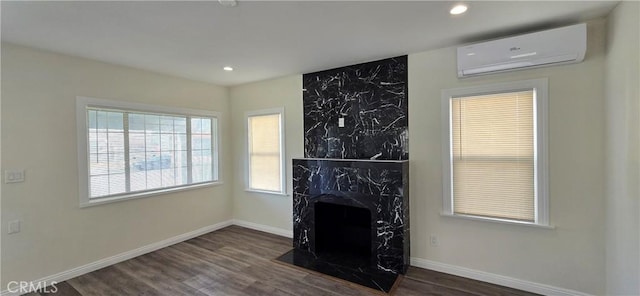 living room with dark hardwood / wood-style flooring, a fireplace, and a wall mounted AC