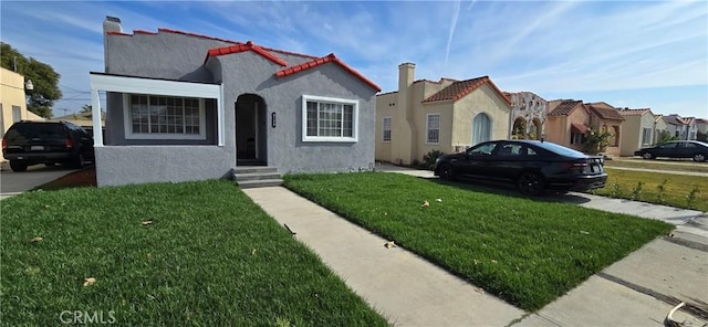 mediterranean / spanish-style home featuring a front yard