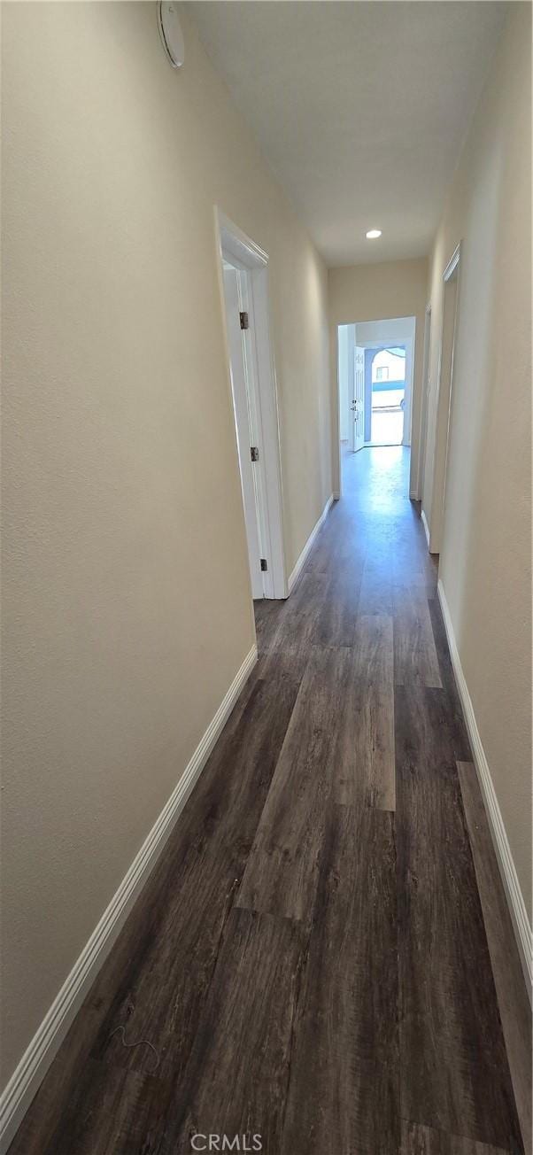 hall with dark hardwood / wood-style flooring