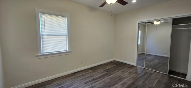 unfurnished bedroom featuring ceiling fan, dark hardwood / wood-style flooring, and a closet