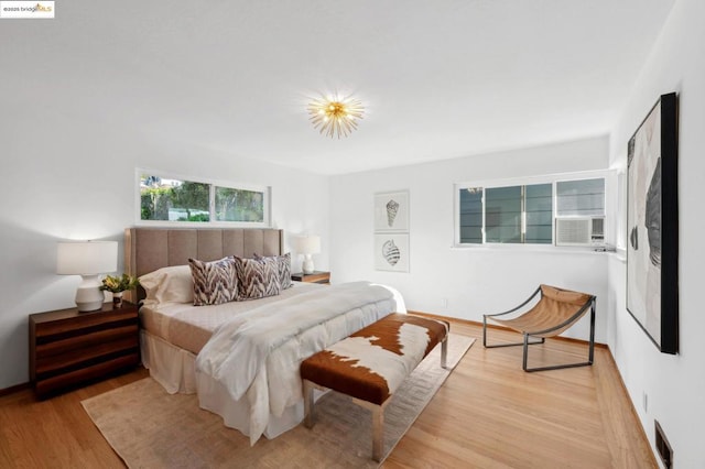 bedroom featuring cooling unit and light hardwood / wood-style flooring