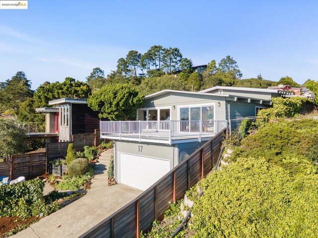 rear view of property featuring a garage