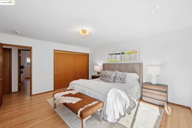 bedroom with a closet and light wood-type flooring