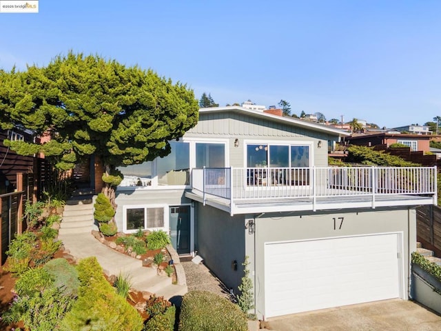 view of front of property featuring a garage and a balcony