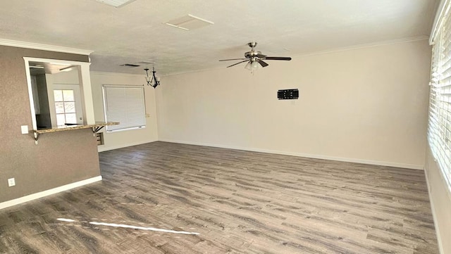 spare room featuring crown molding, dark wood-type flooring, and ceiling fan