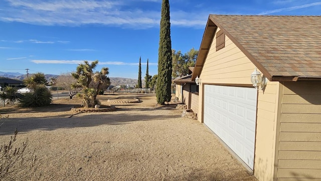 view of home's exterior featuring a garage and a mountain view