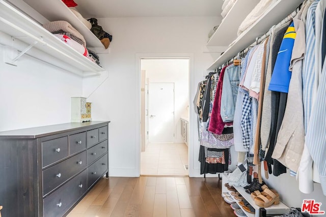 walk in closet featuring hardwood / wood-style flooring