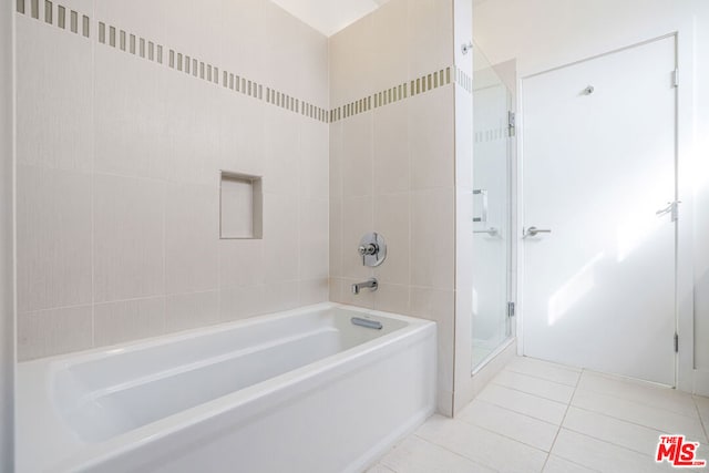 bathroom with tile patterned flooring and separate shower and tub