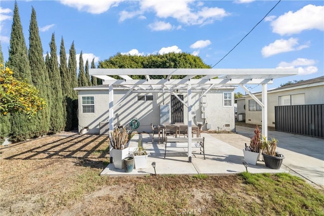 rear view of property with a patio and a pergola