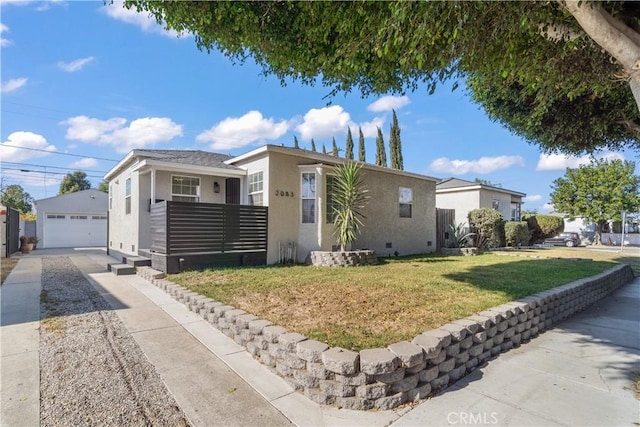 view of front of home with a garage, an outdoor structure, and a front yard