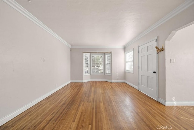 unfurnished room featuring hardwood / wood-style flooring and ornamental molding