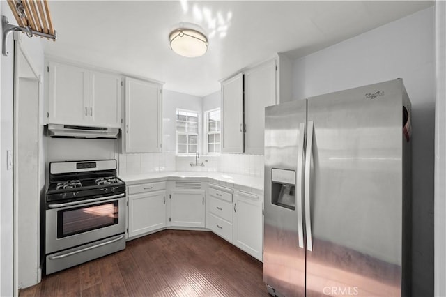 kitchen with white cabinetry, sink, decorative backsplash, stainless steel appliances, and dark wood-type flooring