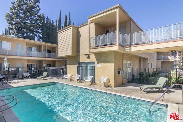 rear view of property featuring a community pool