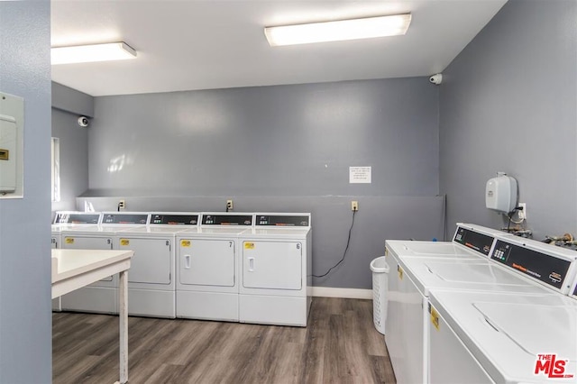 washroom with wood-type flooring and independent washer and dryer