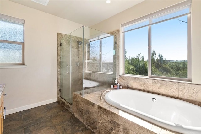 bathroom with vanity and shower with separate bathtub