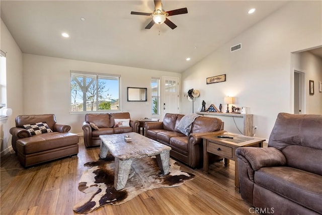 living room featuring ceiling fan, high vaulted ceiling, and light wood-type flooring