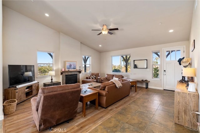 living room featuring vaulted ceiling, a healthy amount of sunlight, and ceiling fan