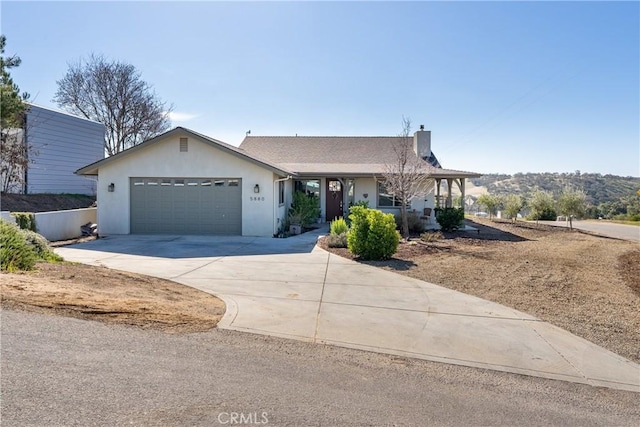 single story home with a garage and a mountain view