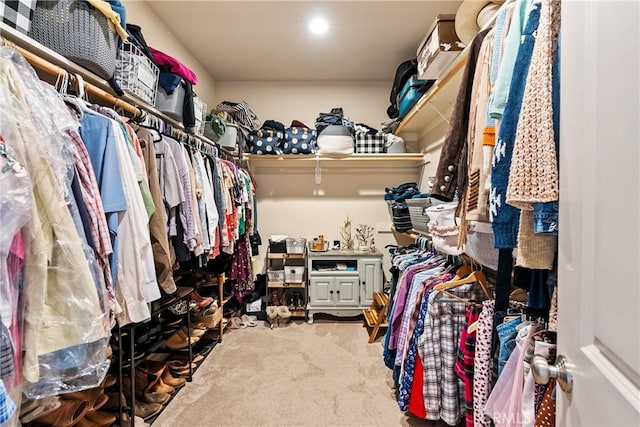 walk in closet with carpet