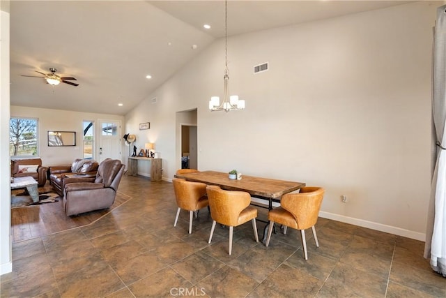 dining room featuring ceiling fan with notable chandelier and high vaulted ceiling