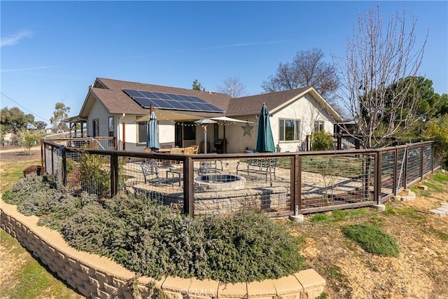 rear view of house with solar panels