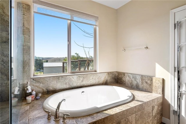 bathroom featuring independent shower and bath