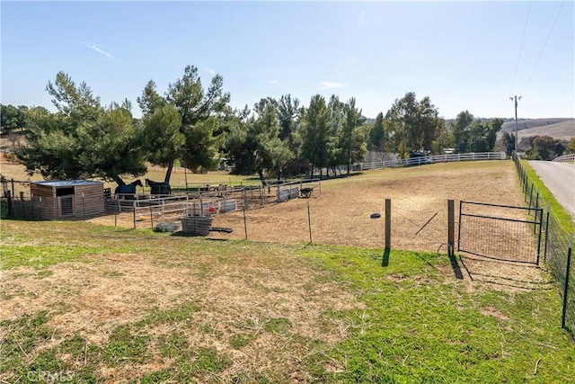 exterior space with an outdoor structure and a rural view