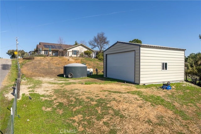 view of yard with a garage and an outdoor structure