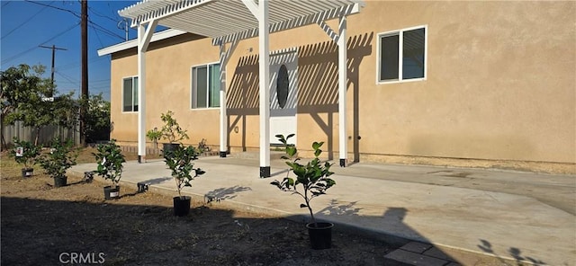 view of home's exterior featuring a pergola and a patio area