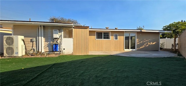 back of house featuring ac unit, a patio area, and a lawn