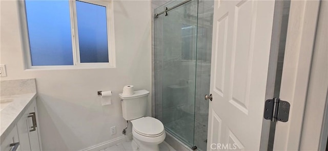 bathroom featuring a shower with door, vanity, and toilet