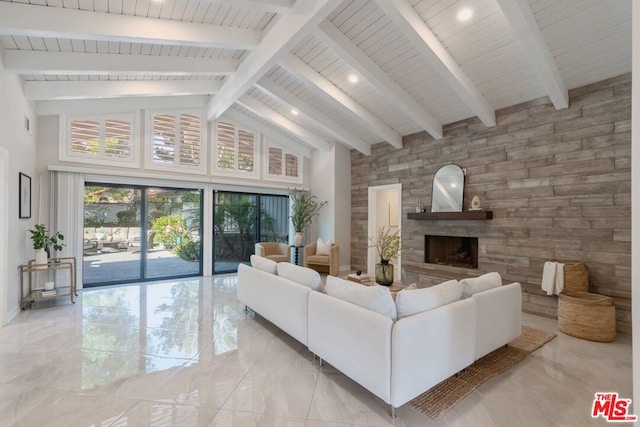 living room featuring beamed ceiling and high vaulted ceiling