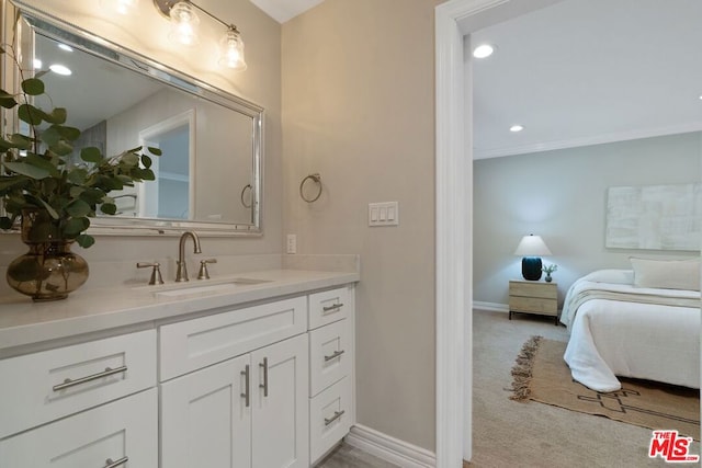 bathroom featuring crown molding and vanity