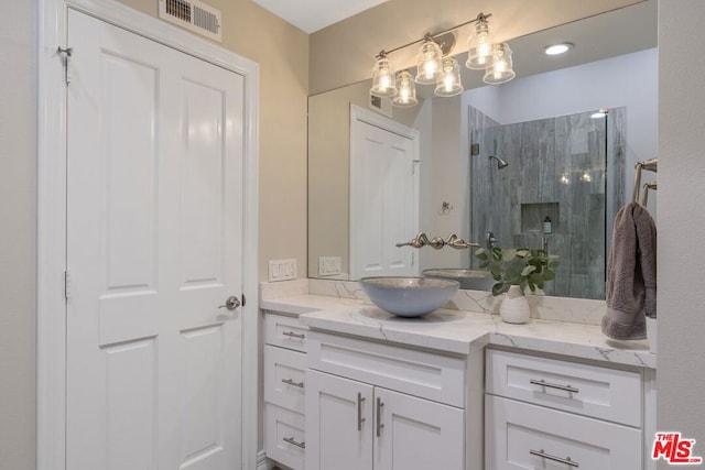 bathroom featuring vanity and a tile shower