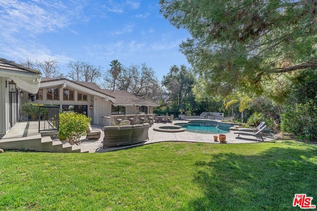 view of swimming pool with an in ground hot tub, outdoor lounge area, a patio area, and a lawn