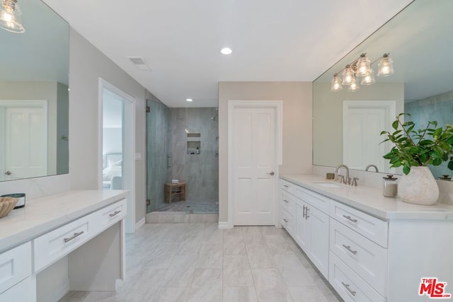 bathroom featuring vanity and a shower with shower door