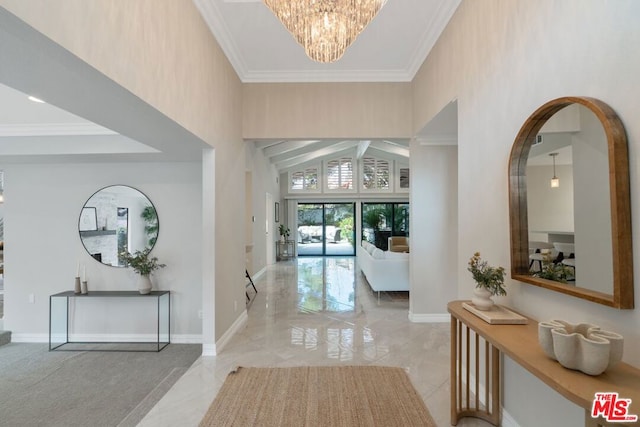 foyer entrance featuring crown molding, a notable chandelier, and high vaulted ceiling